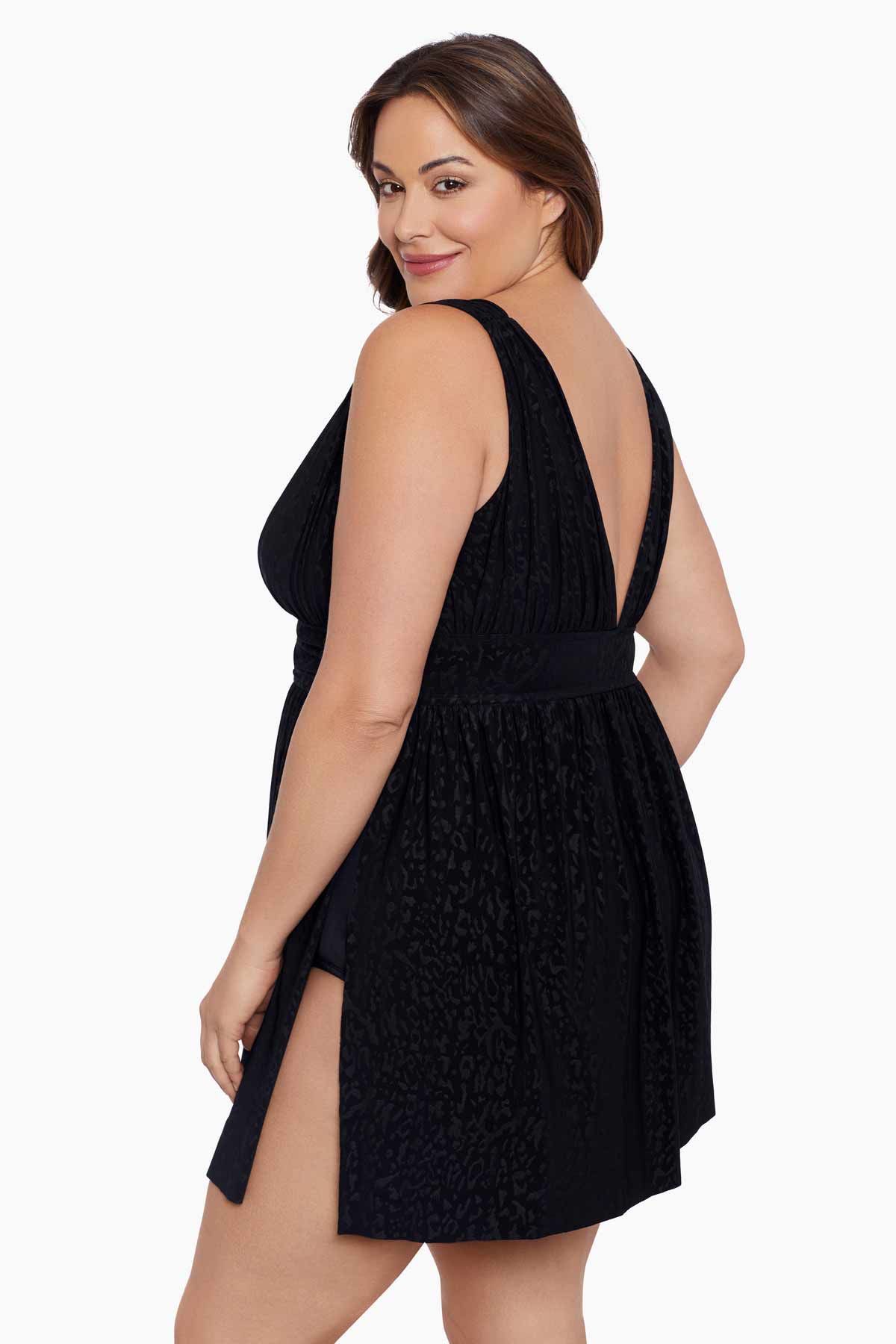 Woman turned left wearing a black light animal-esque printed swim dress