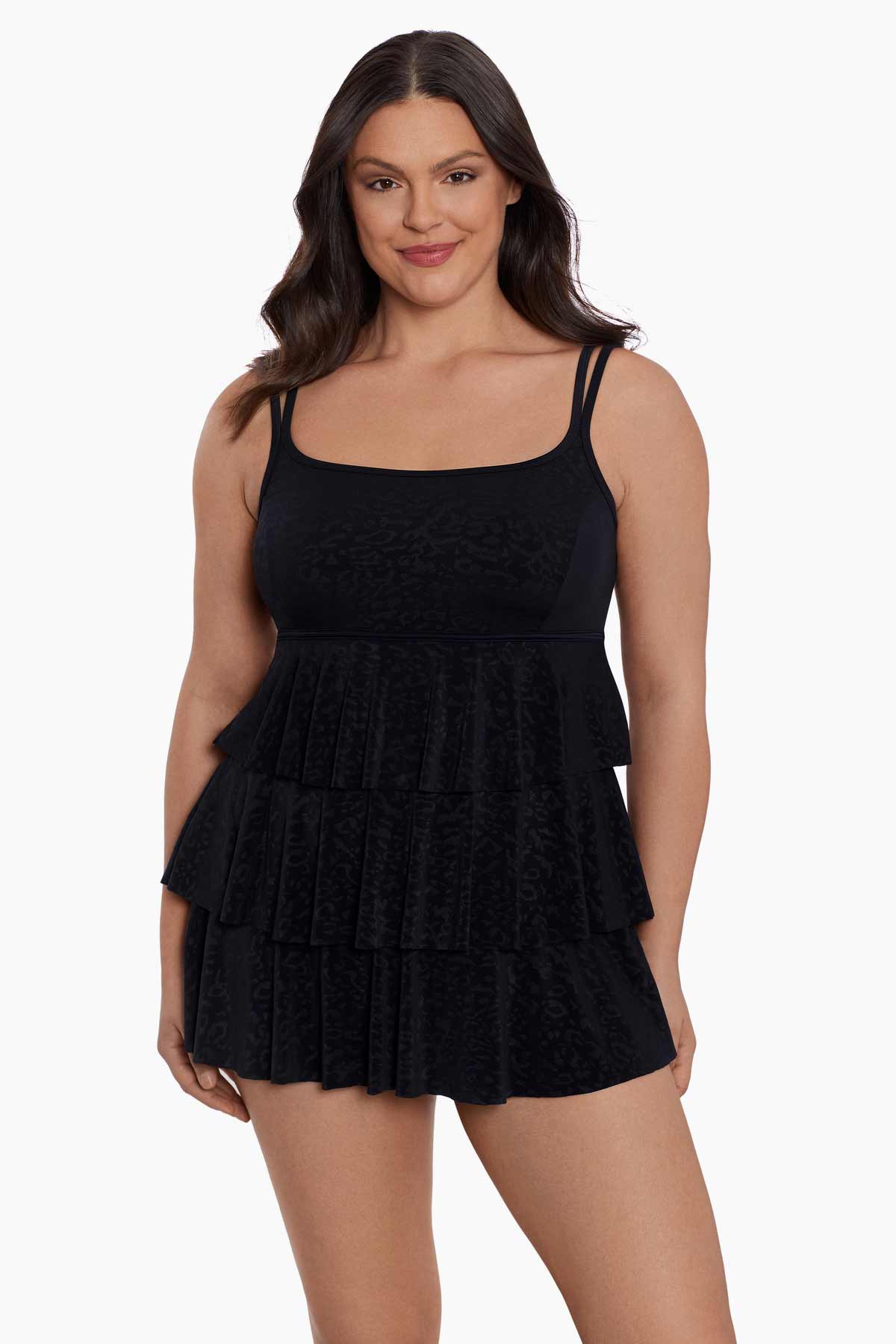 Woman wearing a black faint animal printed tiered swim dress
