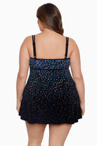 Woman faced away wearing a multicolored speckled pattern black swim dress