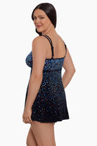 Woman faced left wearing a multicolored dotted pattern swim dress