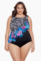 Woman wearing a half zebra print separated by a floral print one-piece swimsuit