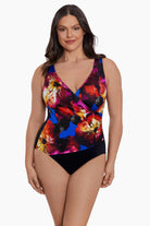 Woman wearing a multicolored watercolor one-piece swimsuit