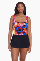 Woman wearing a multicolored watercolor swim dress with a sweetheart neckline