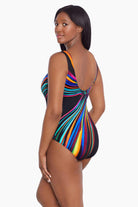 Woman faced left wearing a multicolored stripey light pattern one-piece swimsuit
