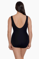 Woman faced away wearing a one-piece swimsuit