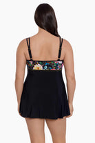 Woman faced away wearing a floral print at the bust swim dress