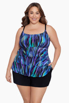 Woman wearing a blue and green streak printed ruffle shortini swimsuit