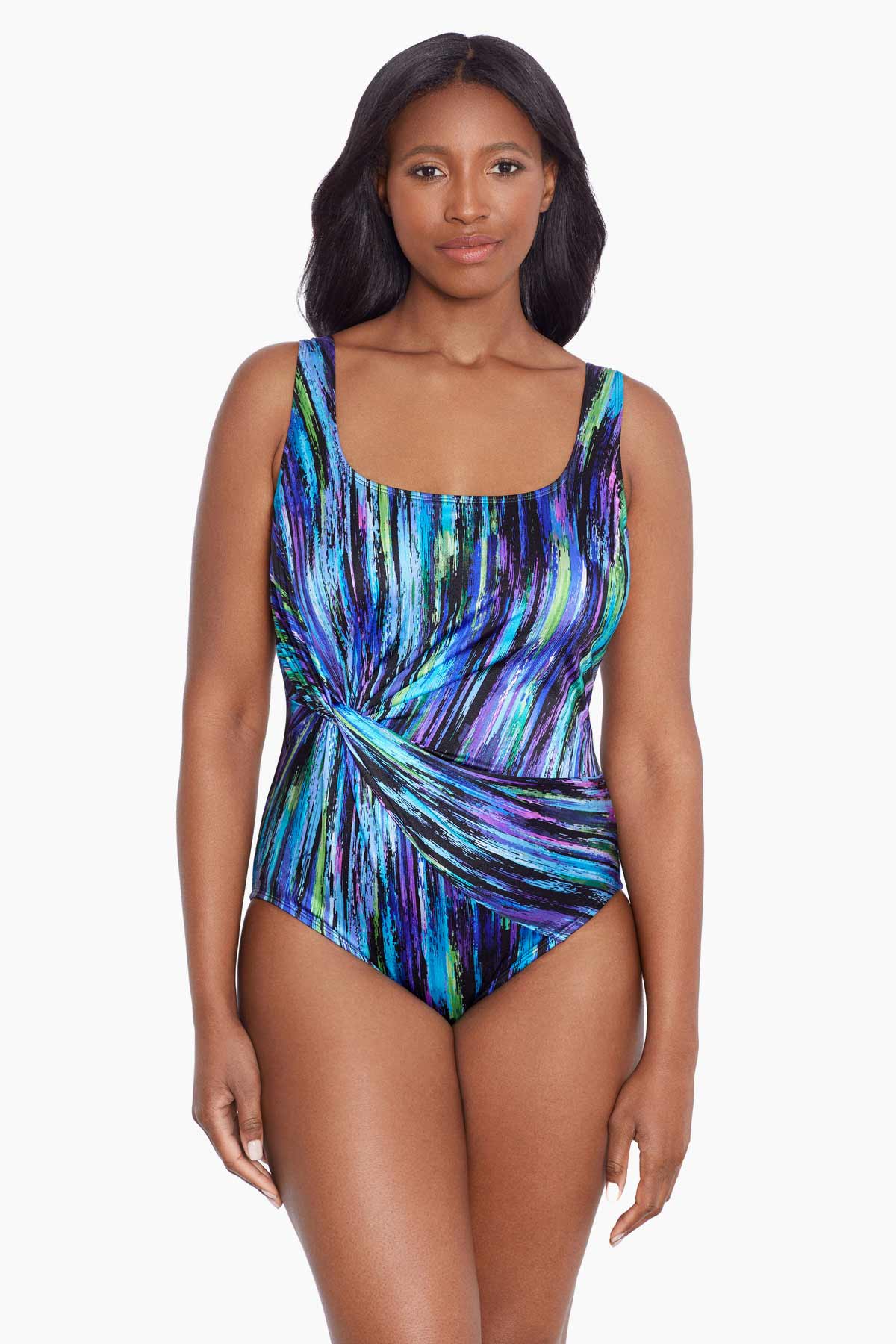 Woman wearing a multicolored streak printed one-piece swimsuit with a side twist