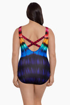 Woman faced away wearing a rainbow tie dye one-piece swimsuit
