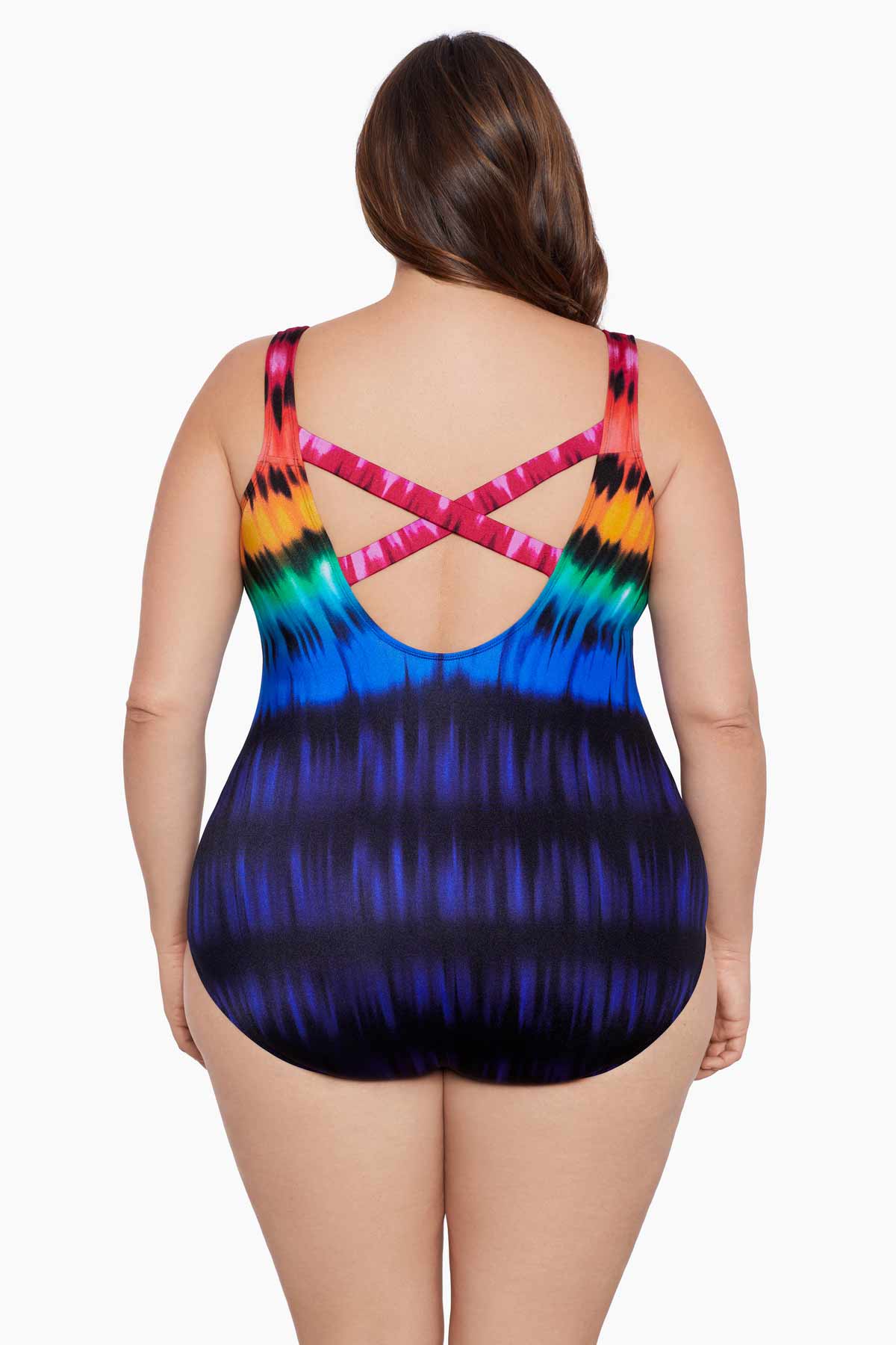 Woman turned away wearing a rainbow tie dye one-piece swimsuit with an X back