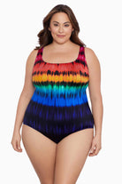 Woman wearing a rainbow tie dye one-piece swimsuit
