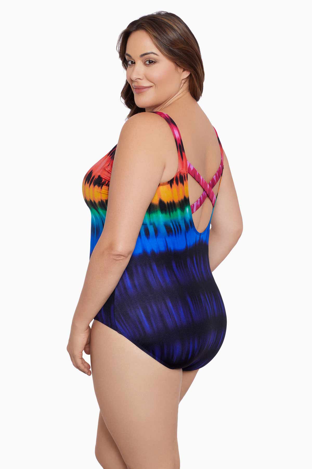 Woman turned left wearing a rainbow tie dye one-piece swimsuit