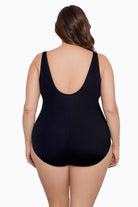 Woman faced away wearing a one-piece swimsuit