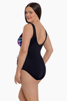 Woman turned left wearing a rainbow ribbon printed one-piece swimsuit