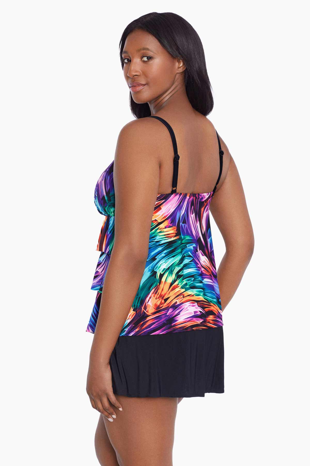 Woman faced left wearing a rainbow ribbon printed ruffle skirtini swimsuit