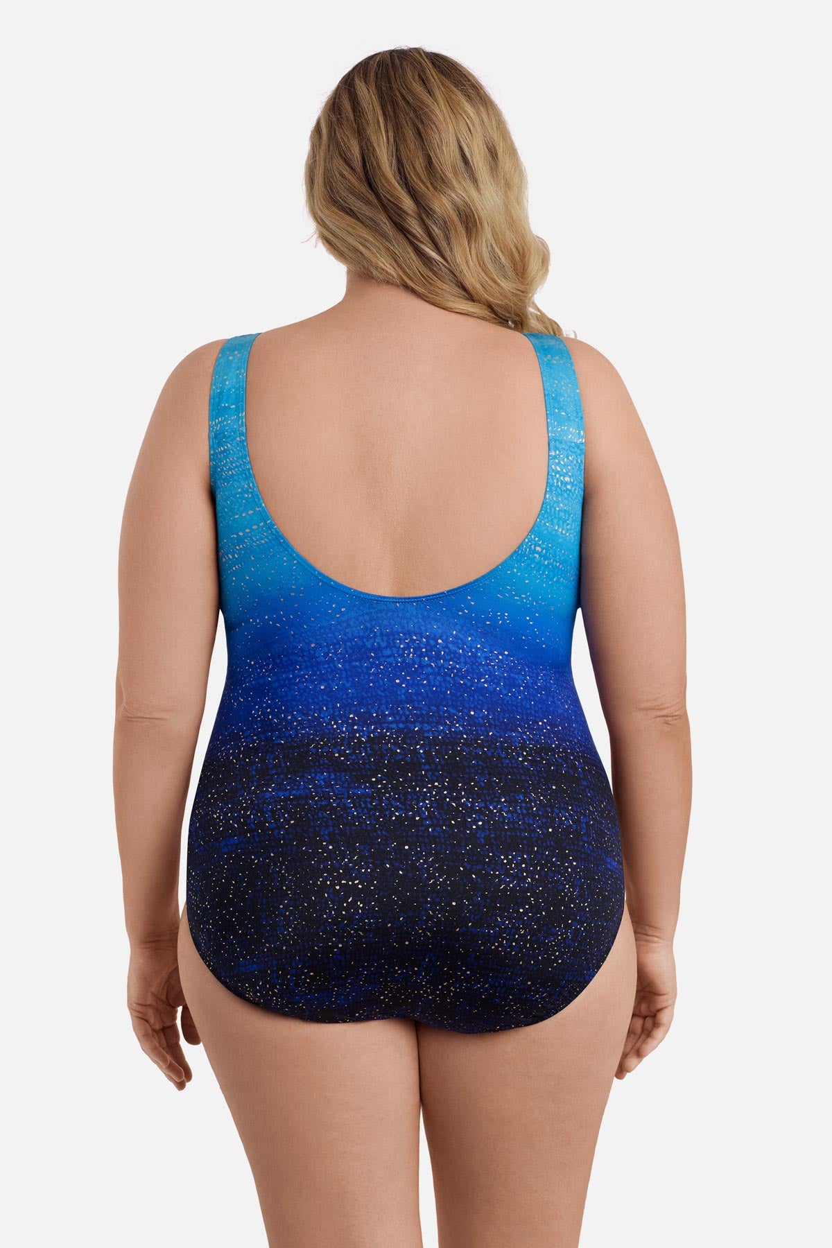 Woman turned away wearing a blue ombre one-piece swimsuit with shimmer detail