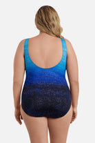 Woman turned away wearing a blue ombre one-piece swimsuit with shimmer detail