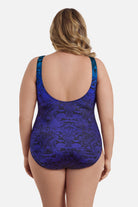 Woman turned away wearing a blue ombre animal-esque printed one-piece swimsuit
