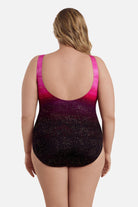 Woman turned away wearing a pink ombre one-piece swimsuit with shimmer detail