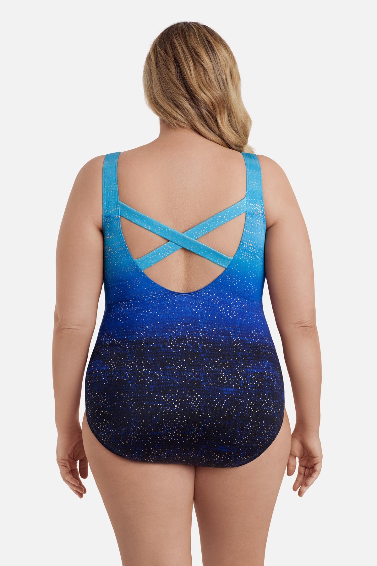 Woman faced away wearing a blue ombre one-piece swimsuit with shimmer detail