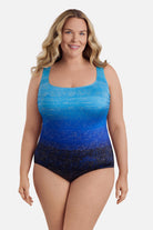 Woman wearing a blue ombre one-piece swimsuit with shimmer detail