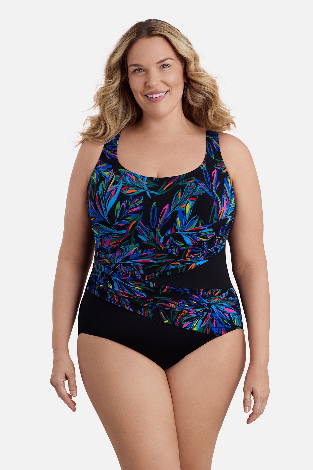 Woman wearing a multicolored abstract printed one-piece swimsuit with a sash effect