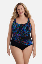Woman wearing a multicolored abstract printed one-piece swimsuit with a sash effect