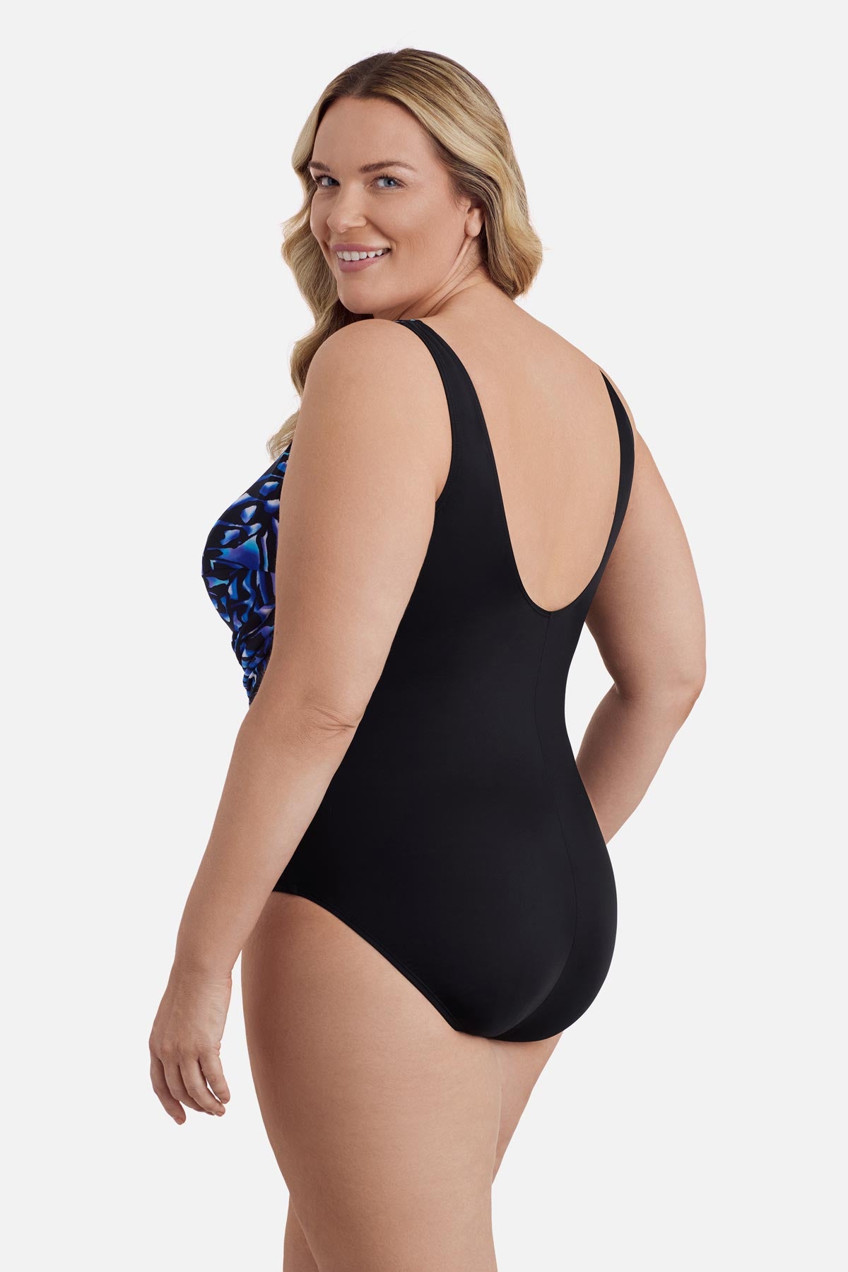 Woman turned left wearing a blue abstract printed one-piece swimsuit 