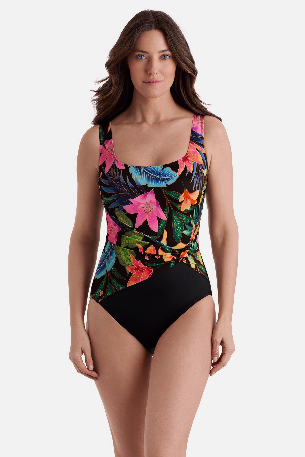 Woman wearing a multicolor floral one-piece swimsuit with a twist on the side