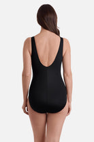 Woman turned away wearing a black swimsuit 