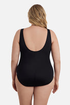 Woman faced away wearing a black mesh high neck one-piece swimsuit