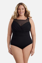 Woman wearing a black mesh high neck one-piece swimsuit