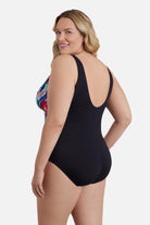 Woman turned left wearing a multicolored abstract printed one-piece swimsuit 