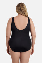 Woman faced away wearing a black one-piece swimsuit