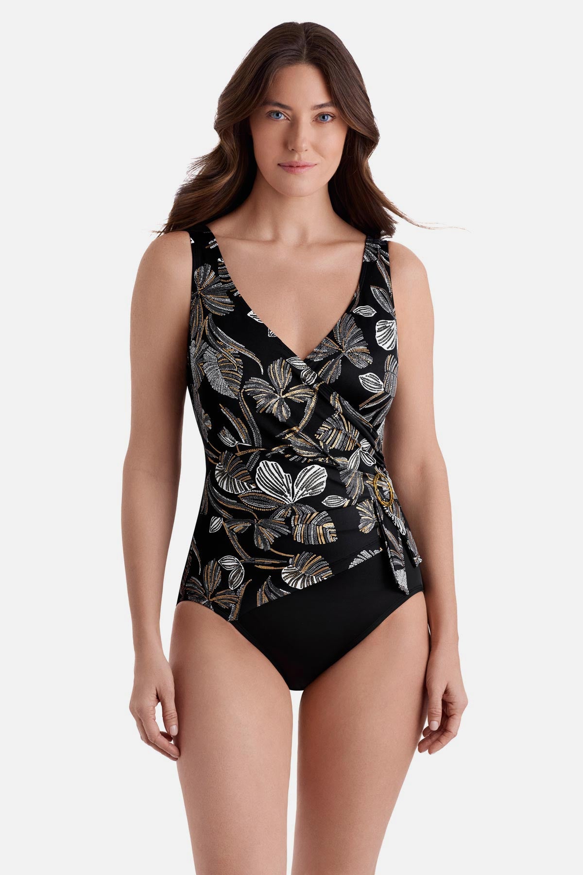 Woman wearing a gold and white floral printed one piece with a v-neck