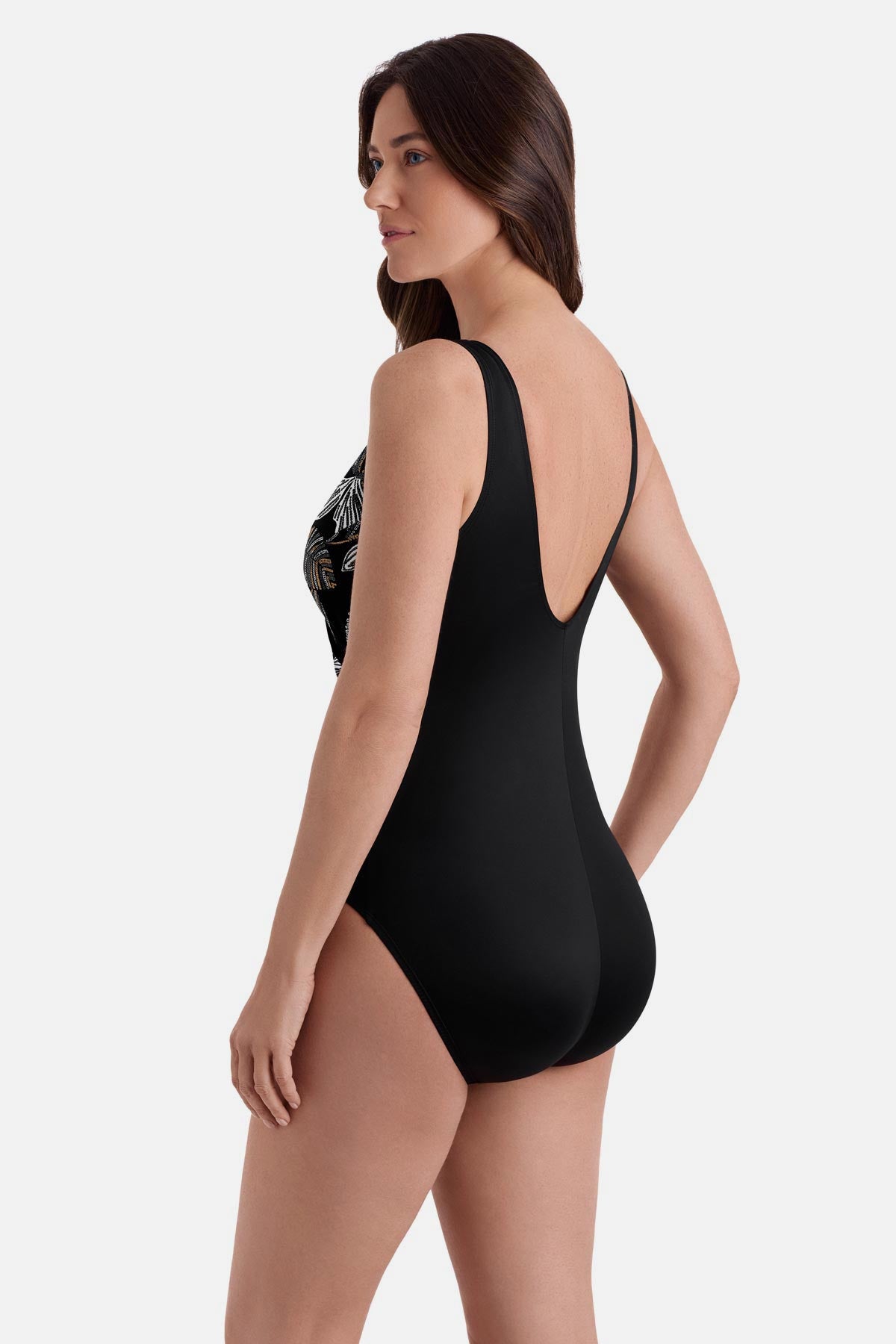 Woman turned left wearing a gold and white floral printed one piece 