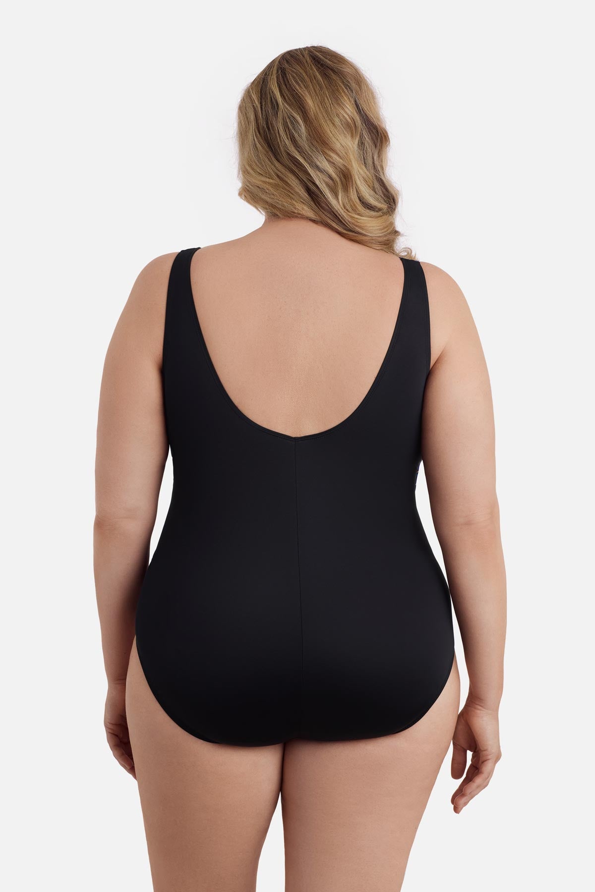 Woman faced away wearing a one-piece swimsuit 