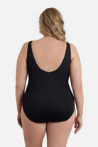 Woman faced away wearing a one-piece swimsuit 