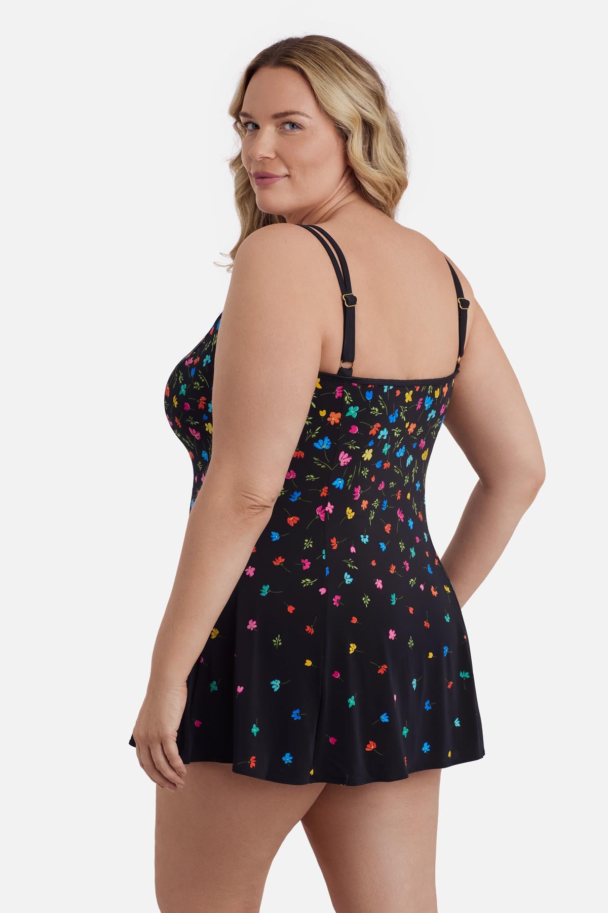 Woman turned left wearing a multicolored floral printed swim dress