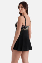 Woman turned left wearing a swim dress with white and gold floral print on the bust