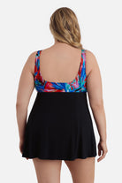 Woman turned away wearing a multicolored abstract print at the bust of the swim dress