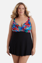 Woman wearing a multicolored abstract print at the bust of the swim dress