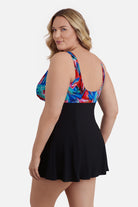 Woman turned left wearing a multicolored abstract print at the bust of the swim dress
