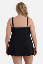 Woman faced away wearing a black swim dress 