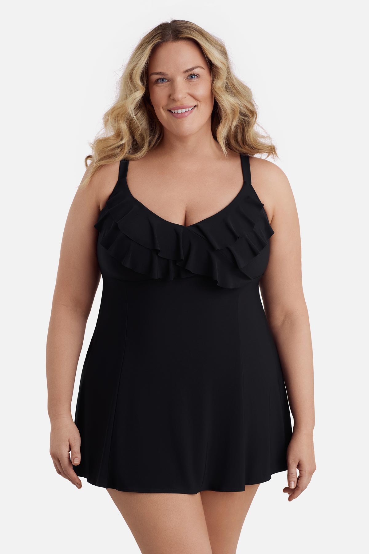 Woman wearing a black swim dress with a ruffled neckline