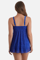 Woman turned away wearing a blue crocheted swim dress