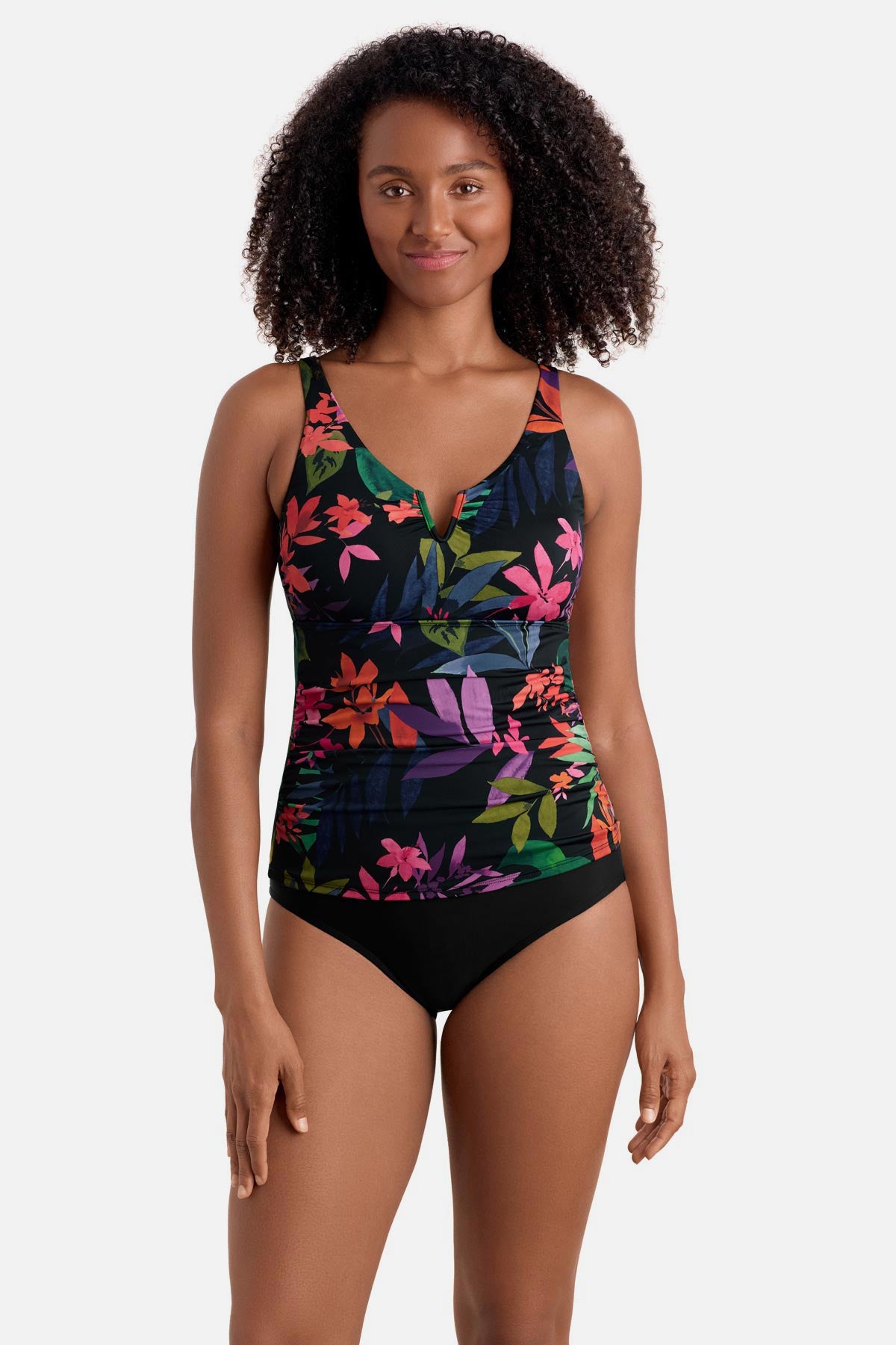 Woman wearing a multicolored floral printed shirred tankini top
