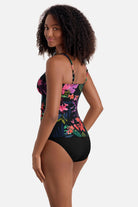 Woman turned left wearing a multicolored floral printed shirred tankini top