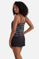 Woman turned left wearing a black and white floral outline pattern high neck tankini top