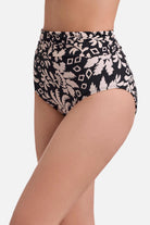 Side view of black and white palm tree printed high waisted swim bottoms